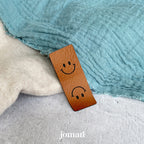 Kunstlederlabel «Klapplabel Smiley» zum Annähen – in der Schweiz lasergraviert